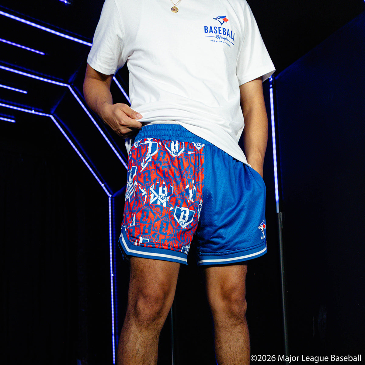 Adult model wearing blue shorts with "Toronto Blue Jays Sticker Court" design