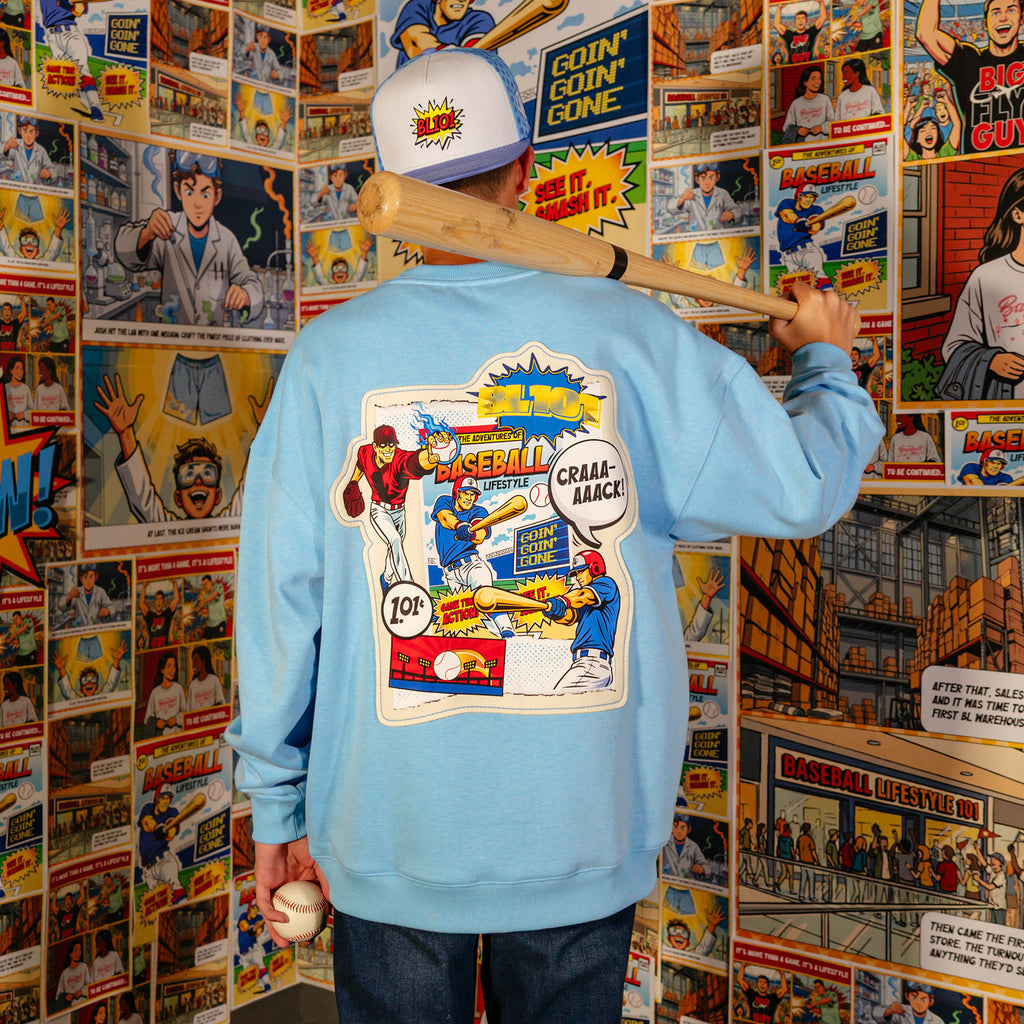 Adult model wearing blue crewneck with "Comic Collage" design