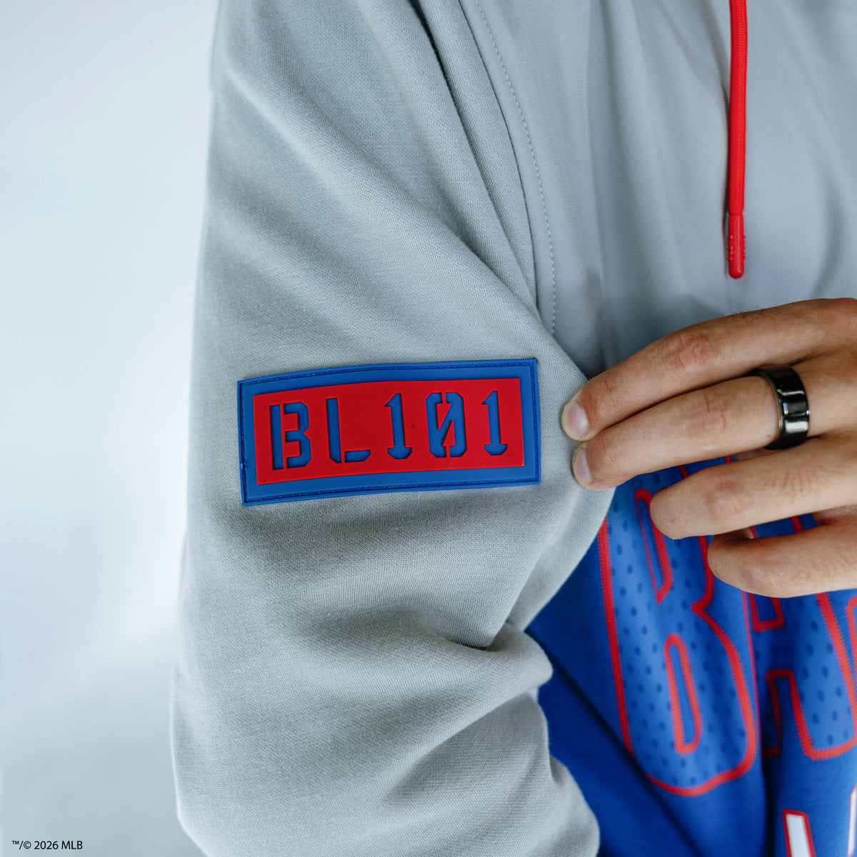 Adult model wearing blue Chicago Cubs Color Block quarter zip
