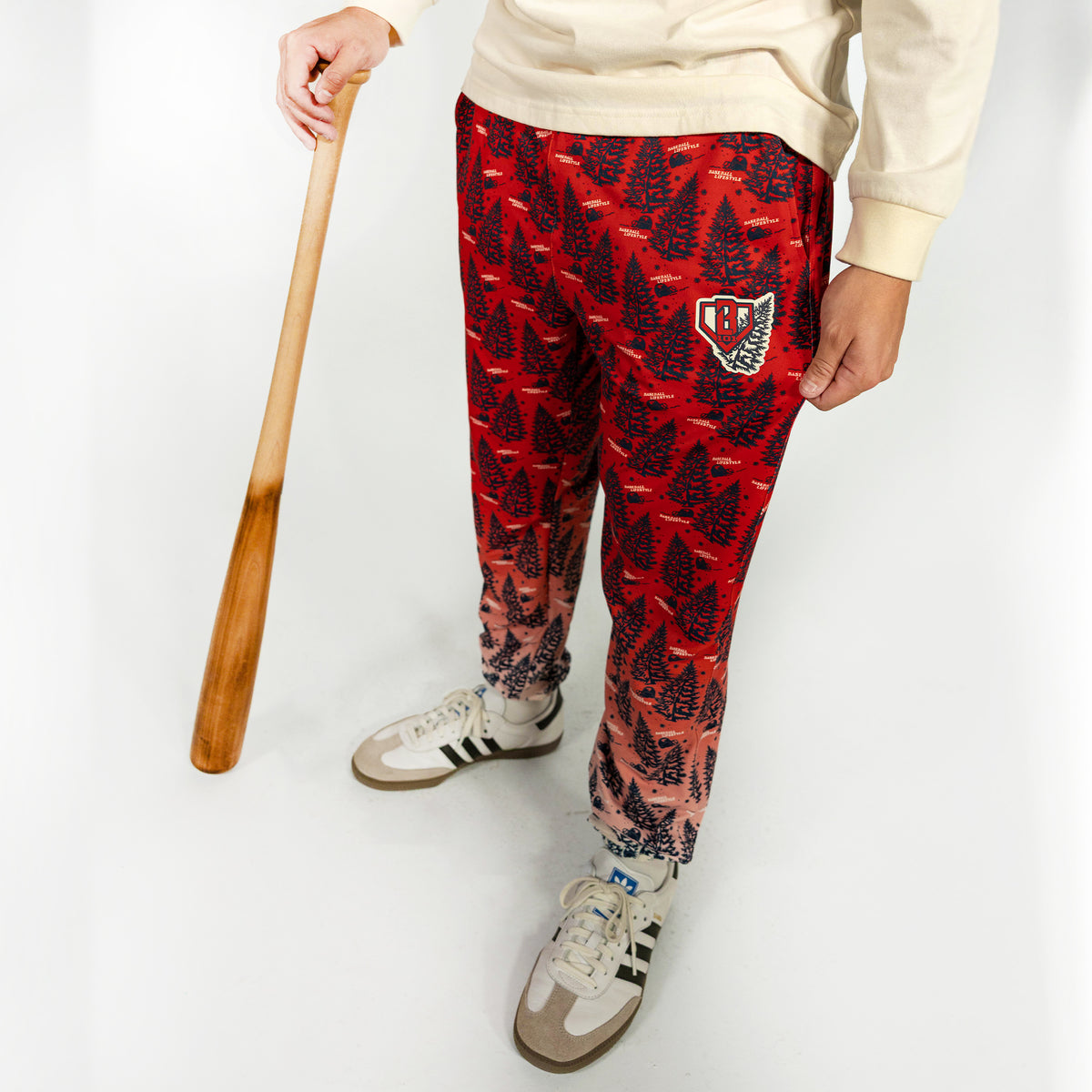 Adult model wearing red pajama pants with "Deck The Halls" design