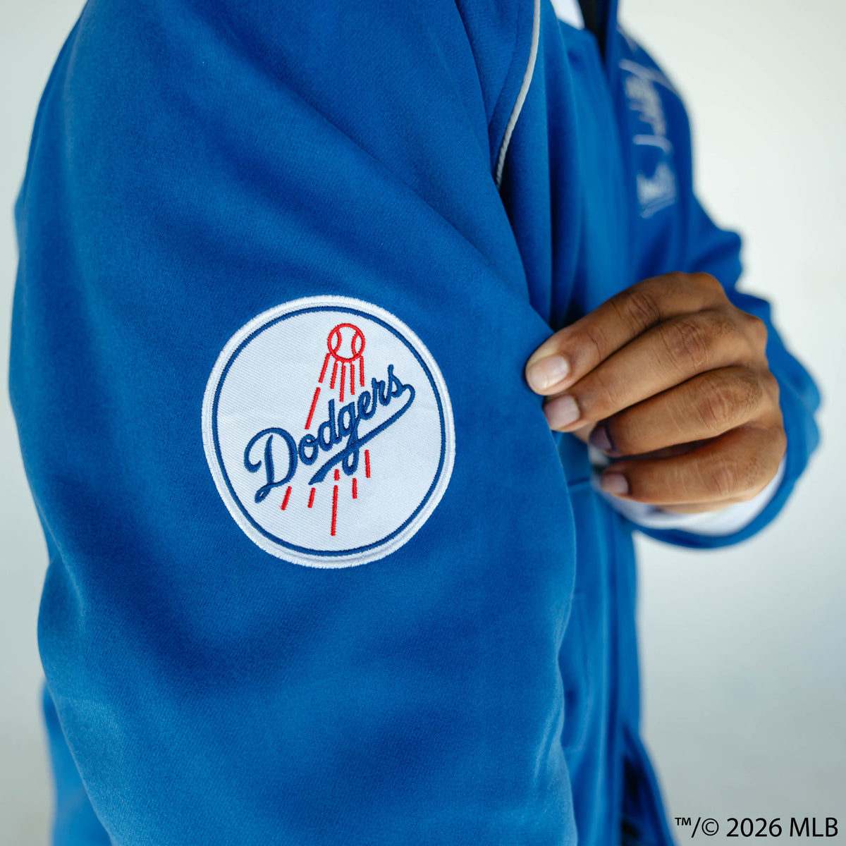 Adult model wearing blue Los Angeles Dodgers Stadium bomber jacket