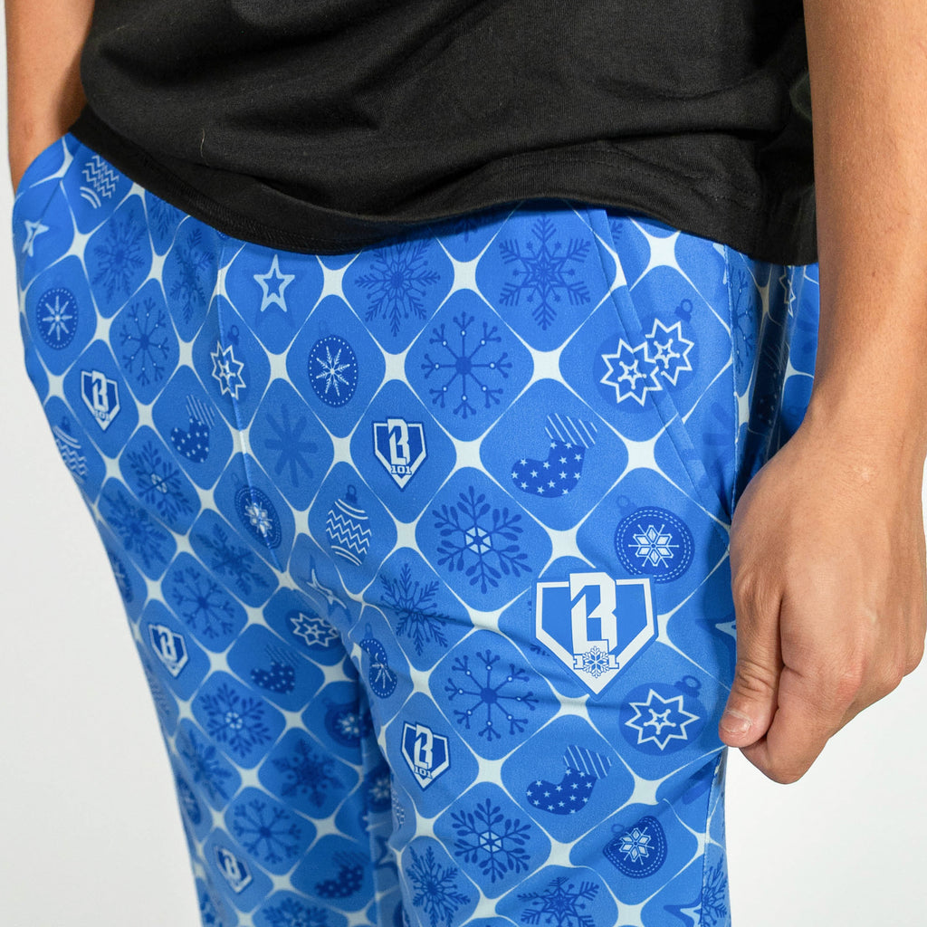 Adult model wearing blue pajama pants with "Frozen Diamond" design