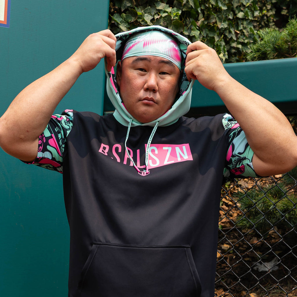 Adult model wearing teal headband with "Hit Tanks" design
