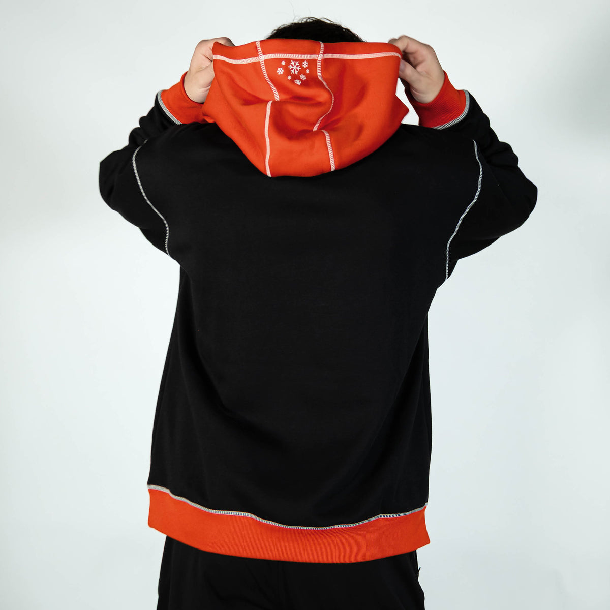 Adult model wearing black hoodie with "Holiday Cookie" design