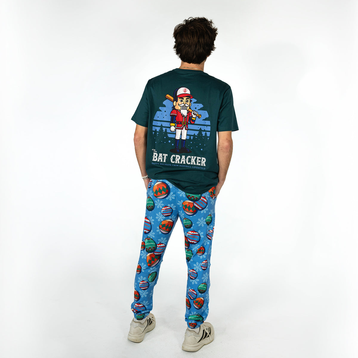 Adult model wearing blue pajama pants with "Jingle Ballers" design