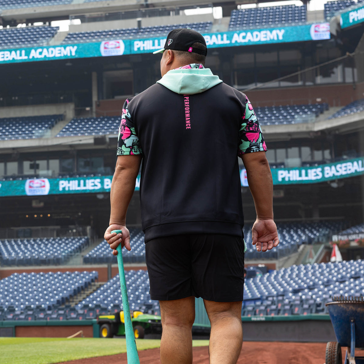 Adult model wearing black short sleeve hoodie with "King Of JUCO BSBL-SZN V3" design