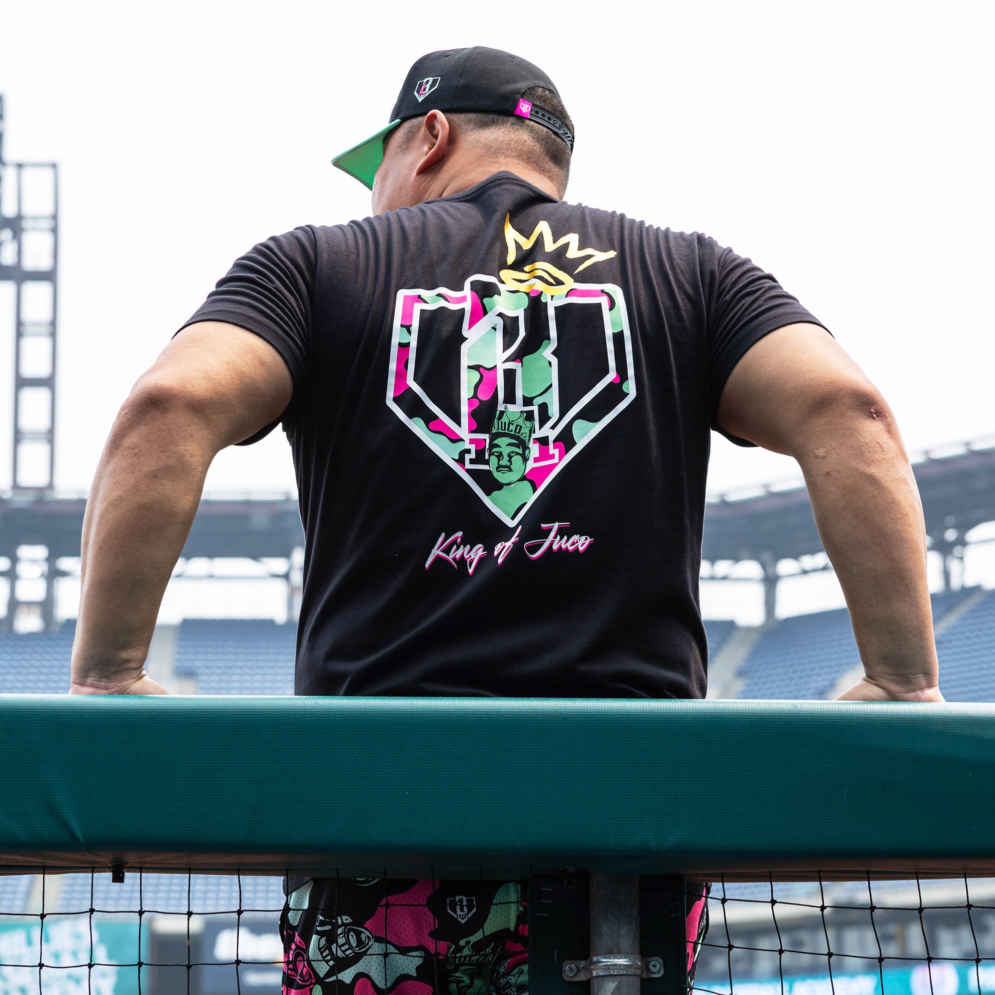 Adult model wearing black graphic tee with "King Of JUCO" design