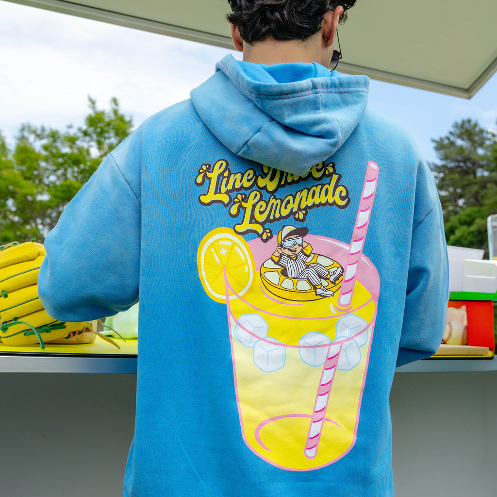 Adult model wearing blue hoodie with "Lemonade Cup" design