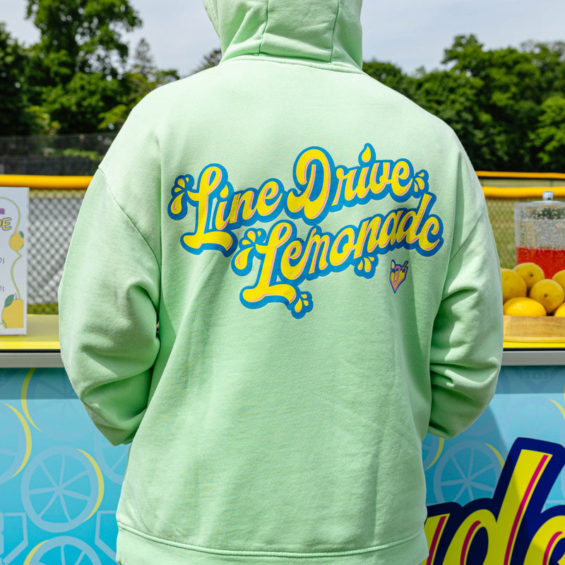 Adult model wearing green hoodie with "Lemonade" design