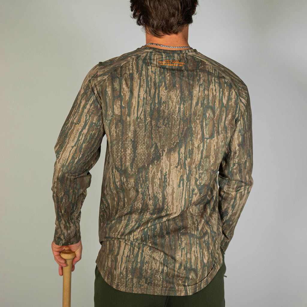 Adult model wearing multi-color Realtree Legacy Diamond Tech Camo long sleeve