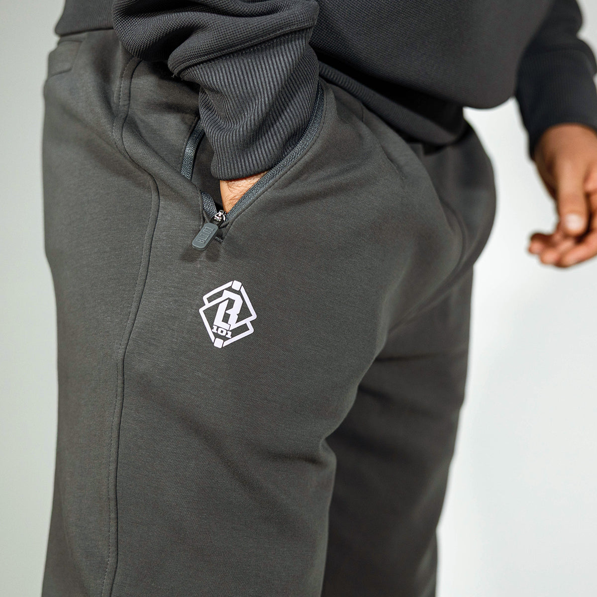 Adult model wearing gray and lilac Diamond Relaxed Fit joggers