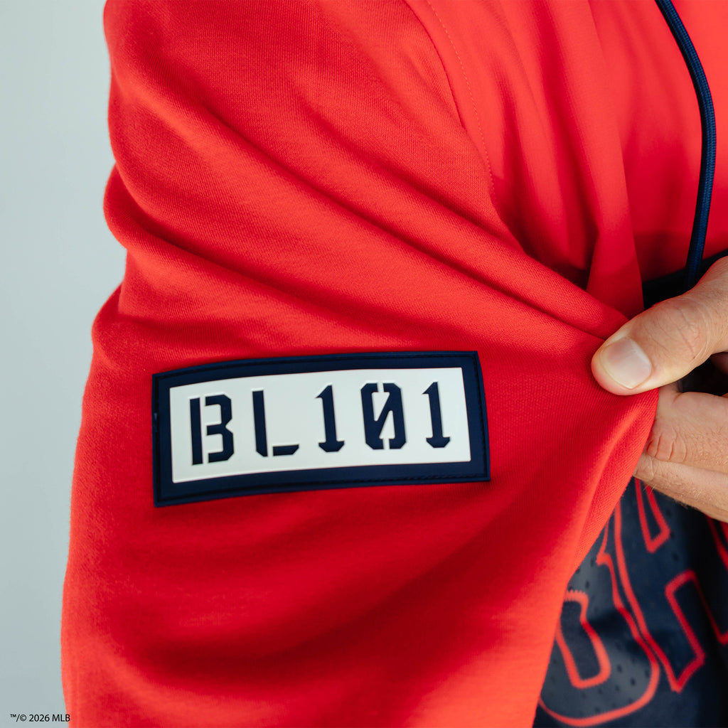Adult model wearing red Boston Red Sox Color Block quarter zip