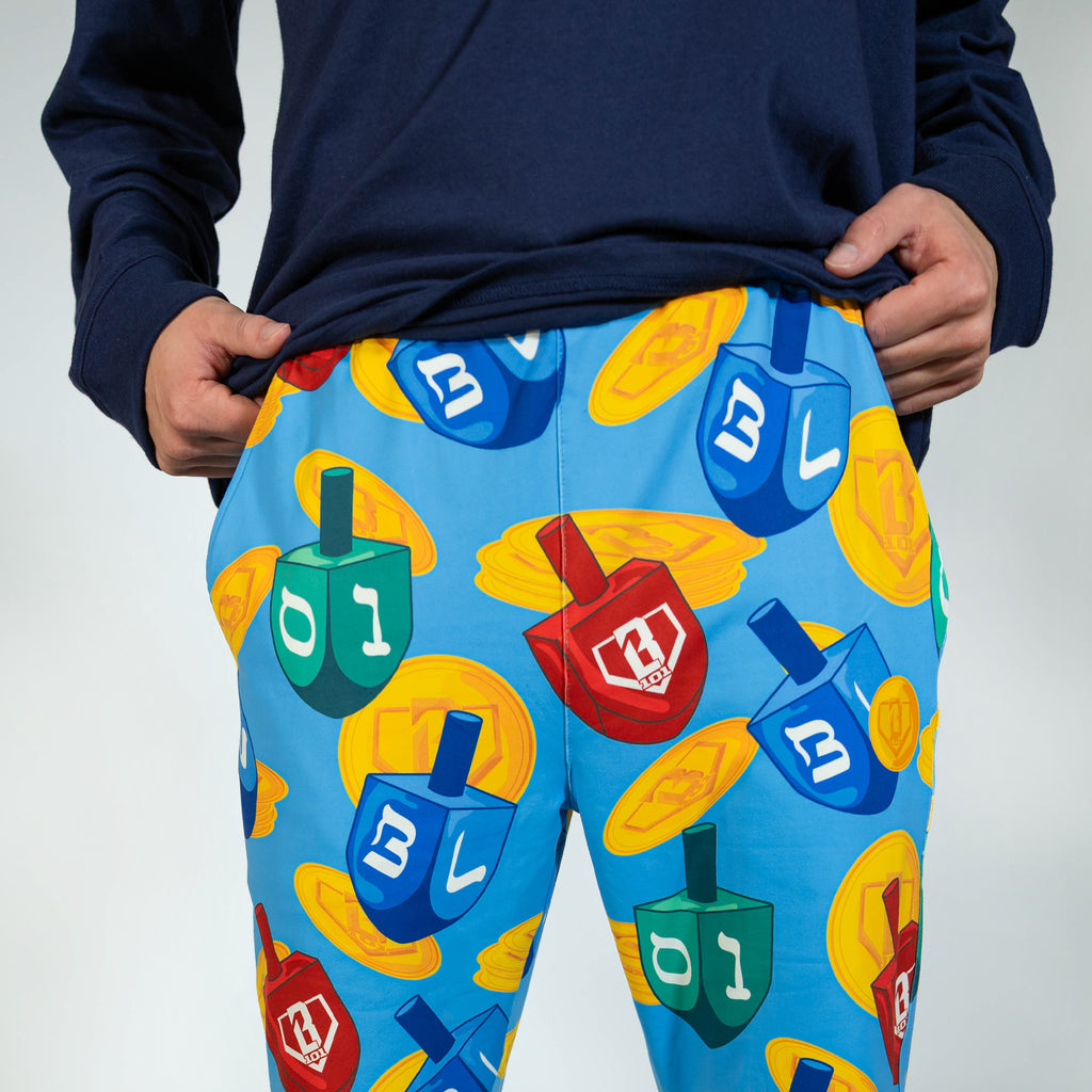 Adult model wearing blue pajama pants with "Spin & Swing" design