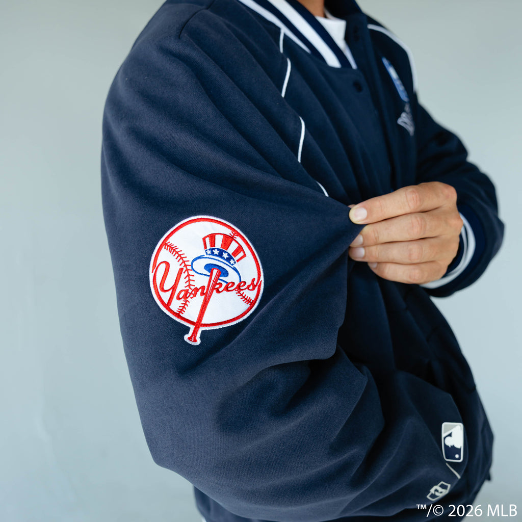 Adult model wearing navy New York Yankees Stadium bomber jacket