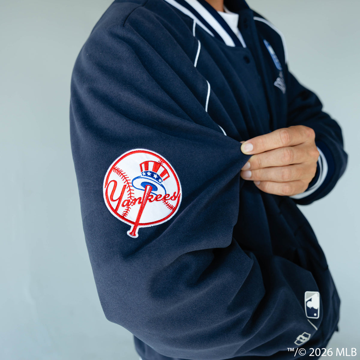 Adult model wearing navy New York Yankees Stadium bomber jacket
