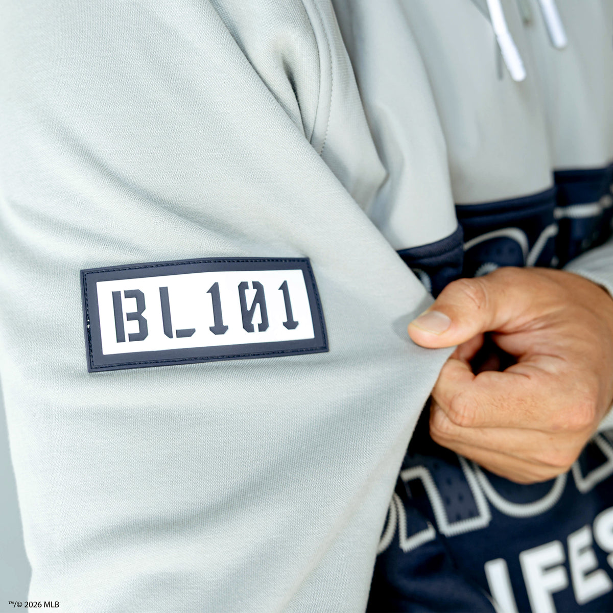 Adult model wearing navy New York Yankees Color Block quarter zip