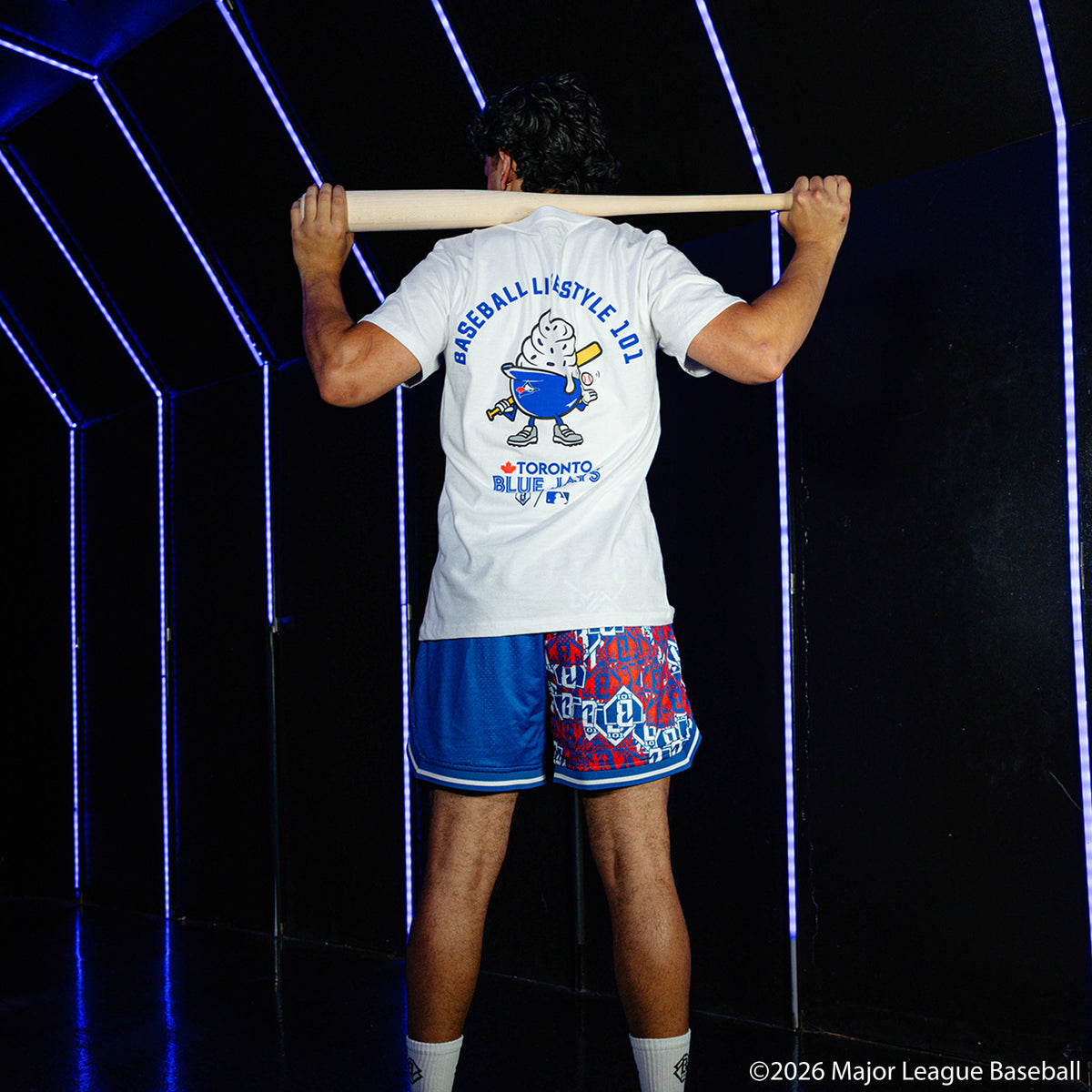 Adult model wearing blue shorts with "Toronto Blue Jays Sticker Court" design