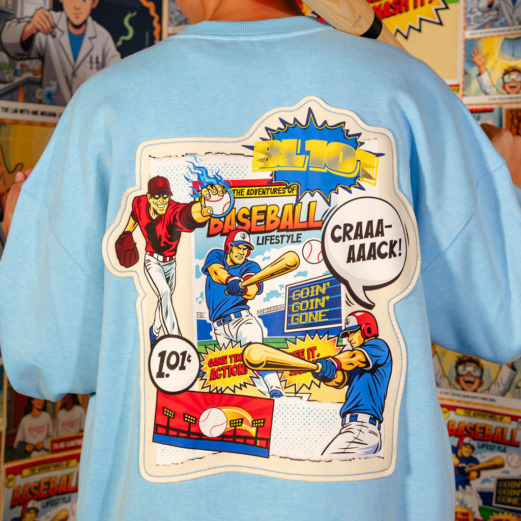 Adult model wearing blue crewneck with "Comic Collage" design