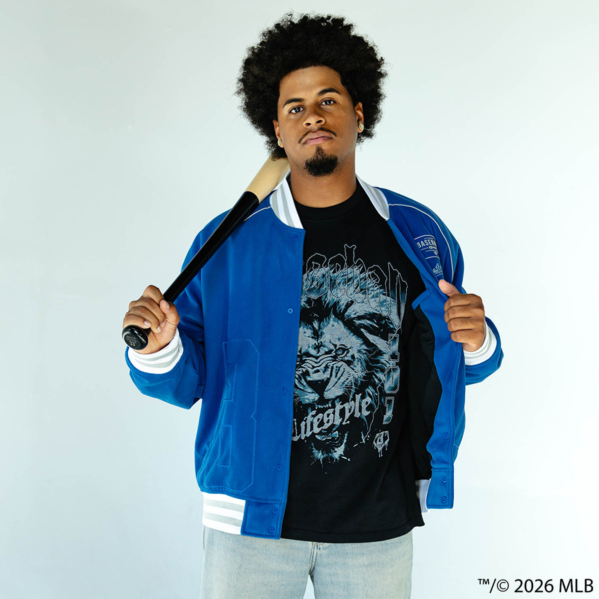 Adult model wearing blue Los Angeles Dodgers Stadium bomber jacket