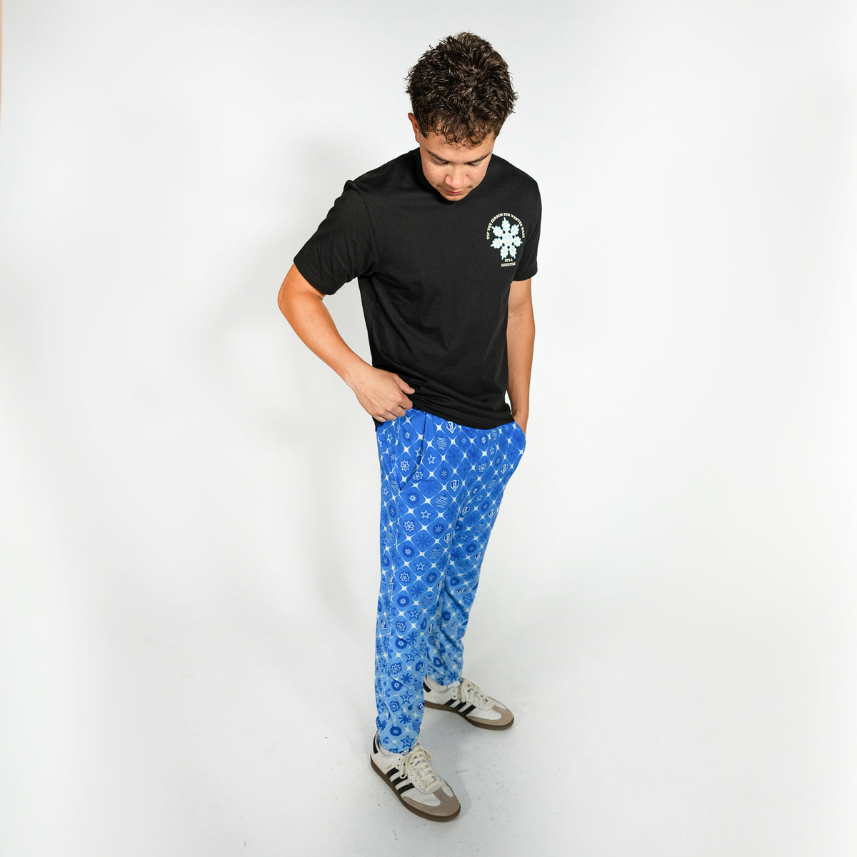 Adult model wearing blue pajama pants with "Frozen Diamond" design