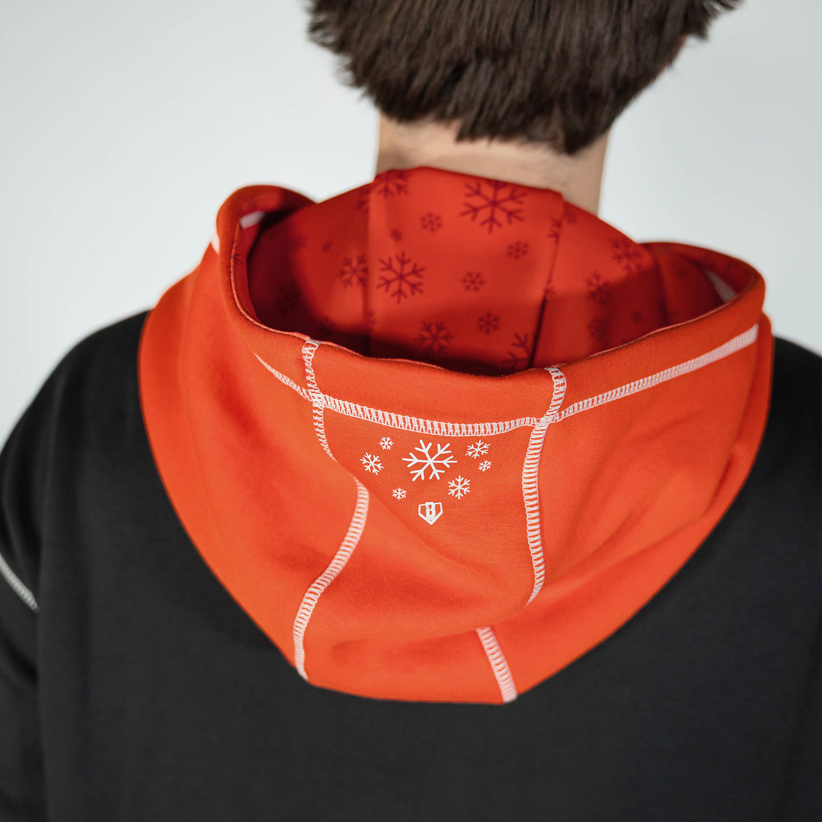 Adult model wearing black hoodie with "Holiday Cookie" design