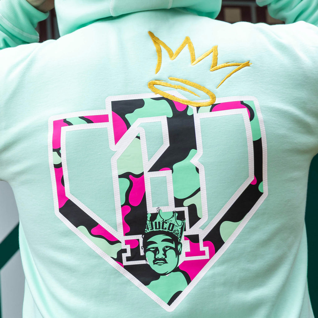 Adult model wearing teal hoodie with "King Of JUCO" design