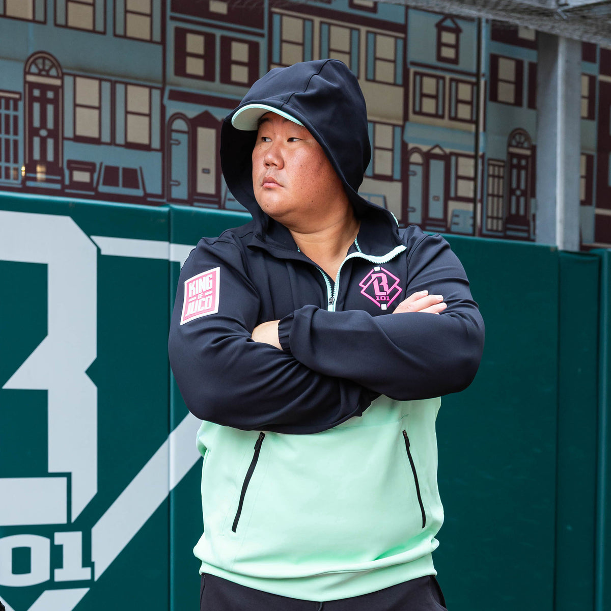 Adult model wearing teal quarter zip hoodie with "King Of JUCO" design