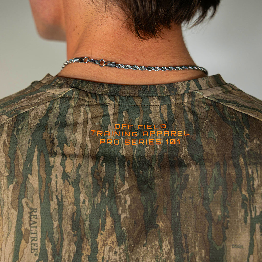 Adult model wearing multi-color Realtree Legacy Diamond Tech Camo long sleeve