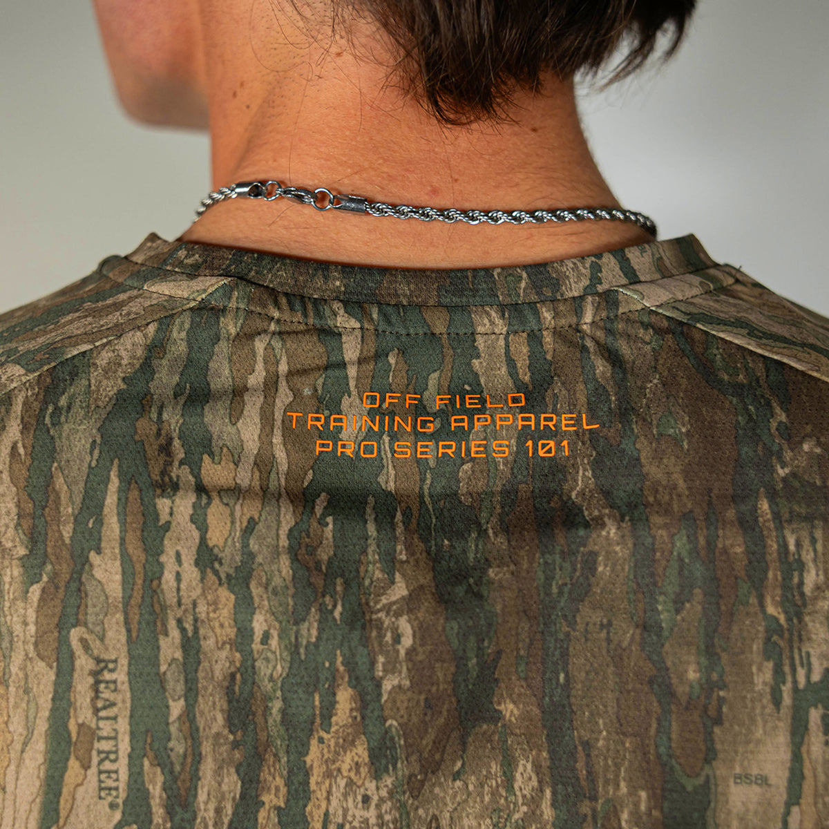 Adult model wearing multi-color Realtree Legacy Diamond Tech Camo long sleeve