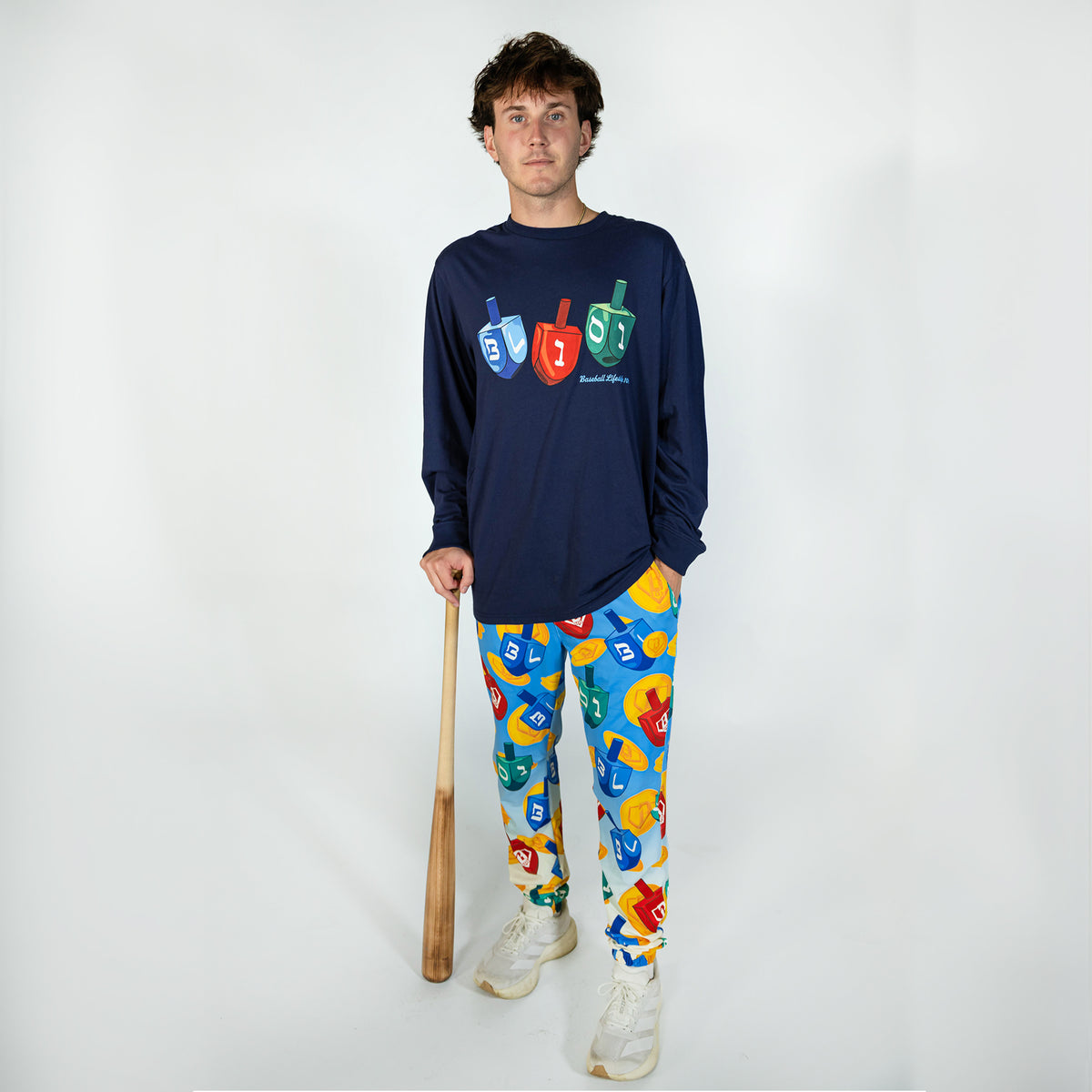 Adult model wearing blue pajama pants with "Spin & Swing" design