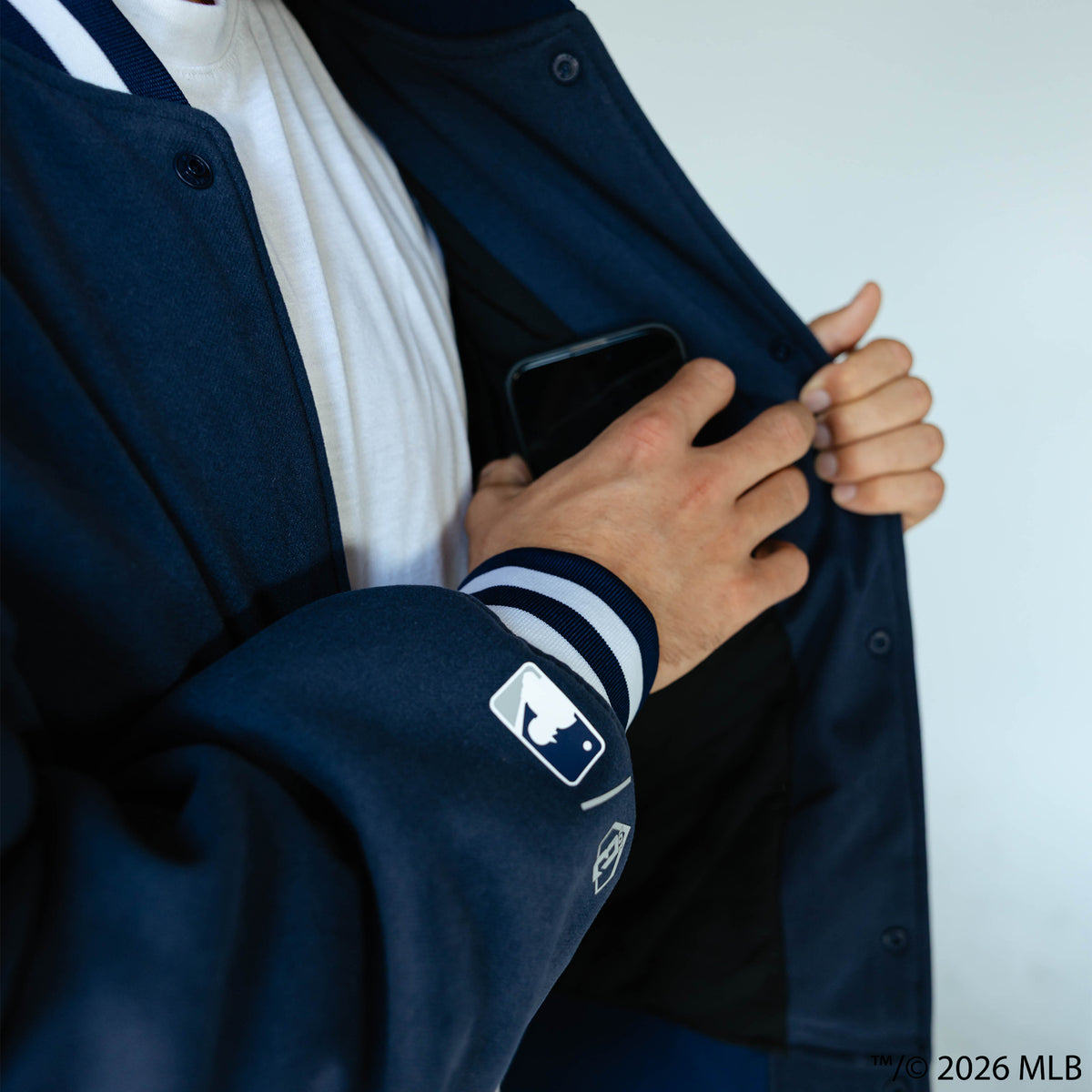 Adult model wearing navy New York Yankees Stadium bomber jacket