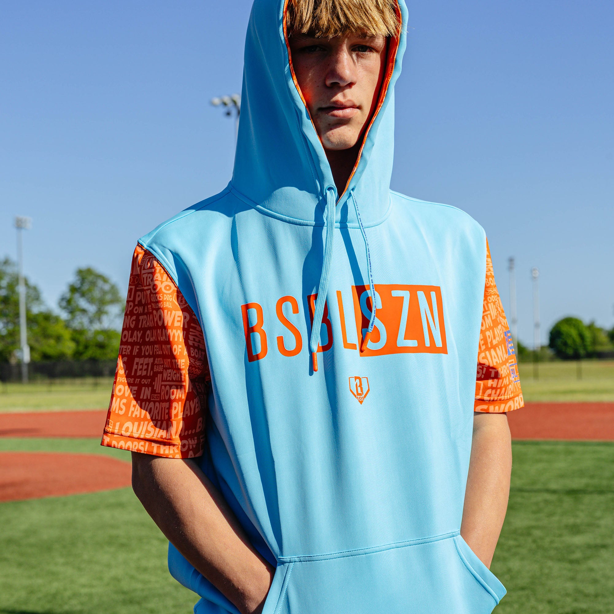 Adult model wearing blue short sleeve hoodie with "BSBL-SZN V3" design