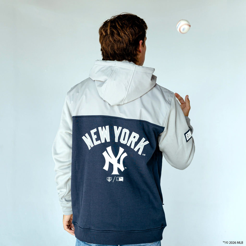 Adult model wearing navy New York Yankees Color Block quarter zip