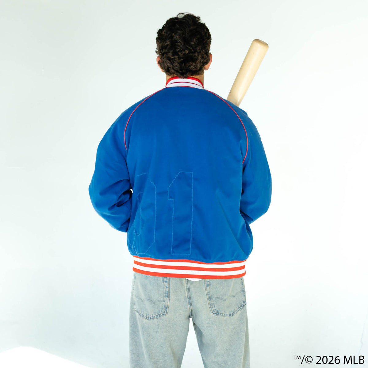 Adult model wearing blue Chicago Cubs Stadium bomber jacket