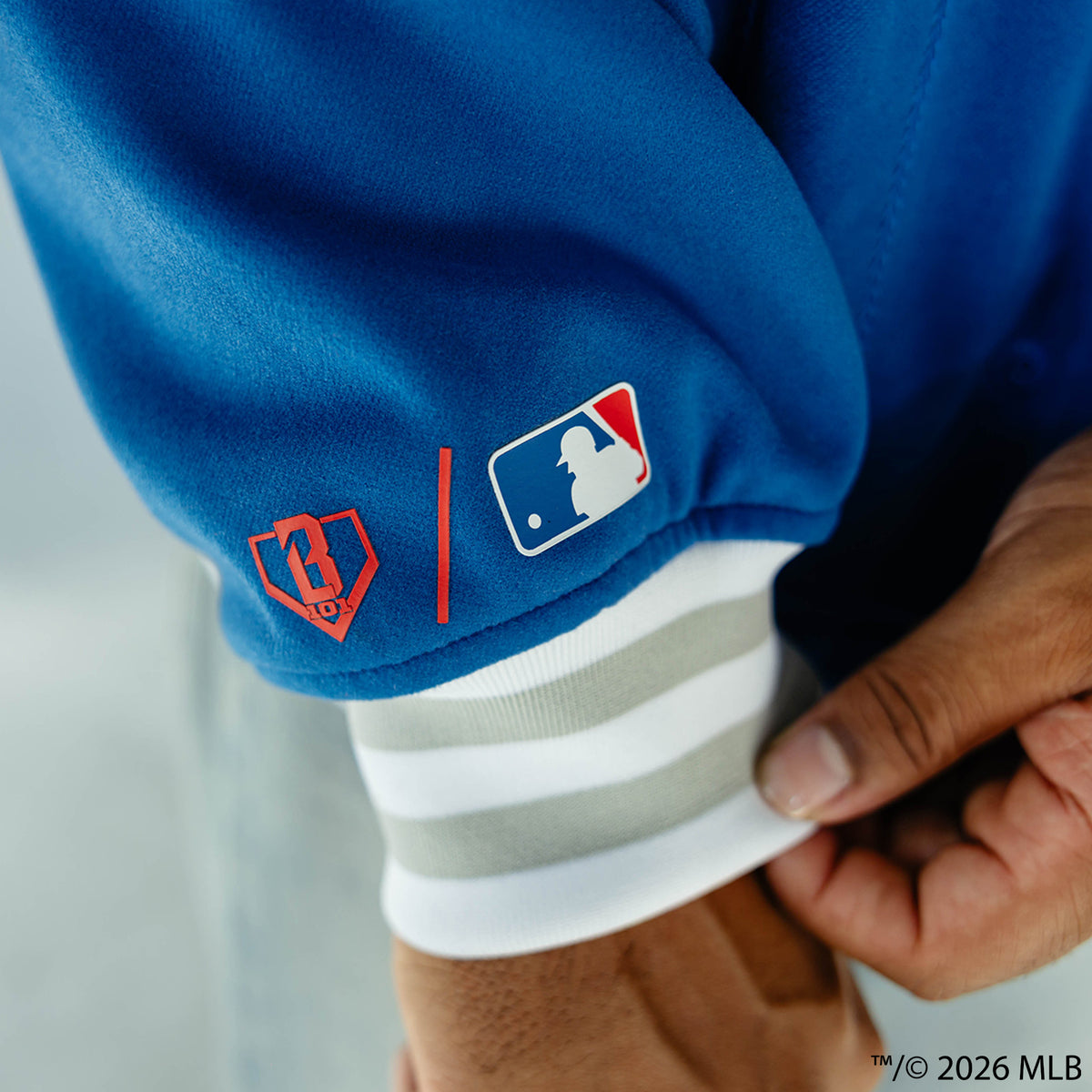 Adult model wearing blue Los Angeles Dodgers Stadium bomber jacket