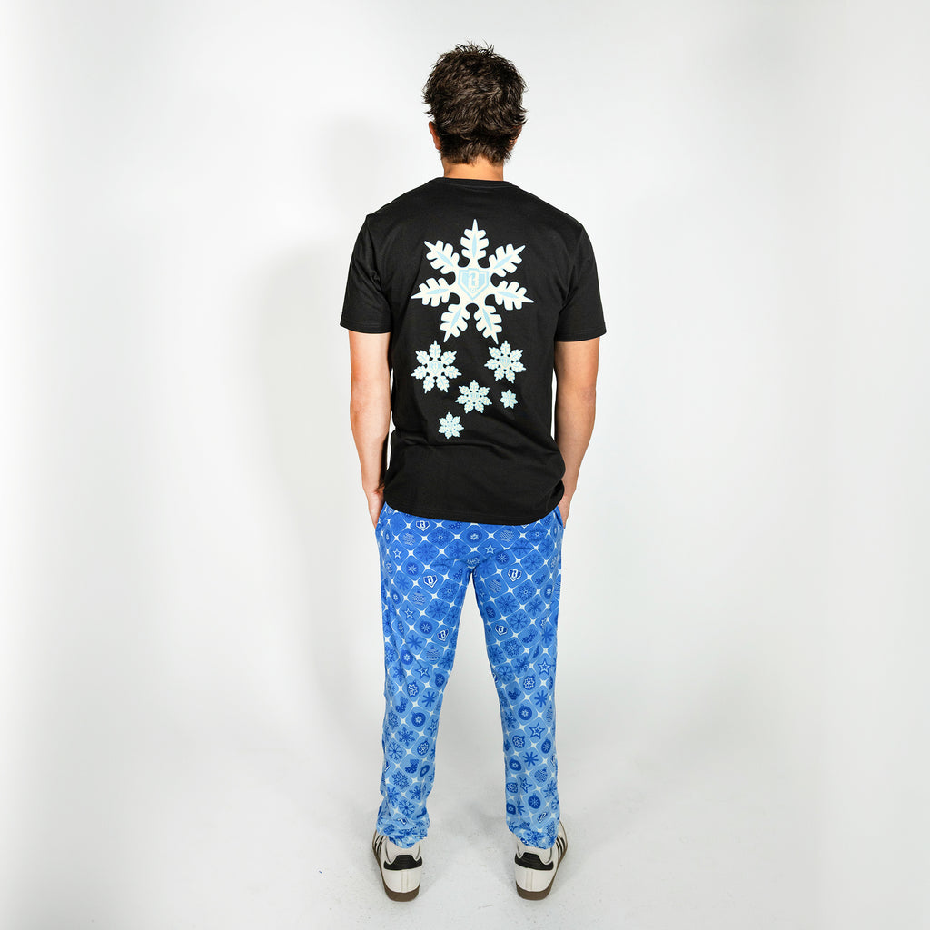 Adult model wearing blue pajama pants with "Frozen Diamond" design