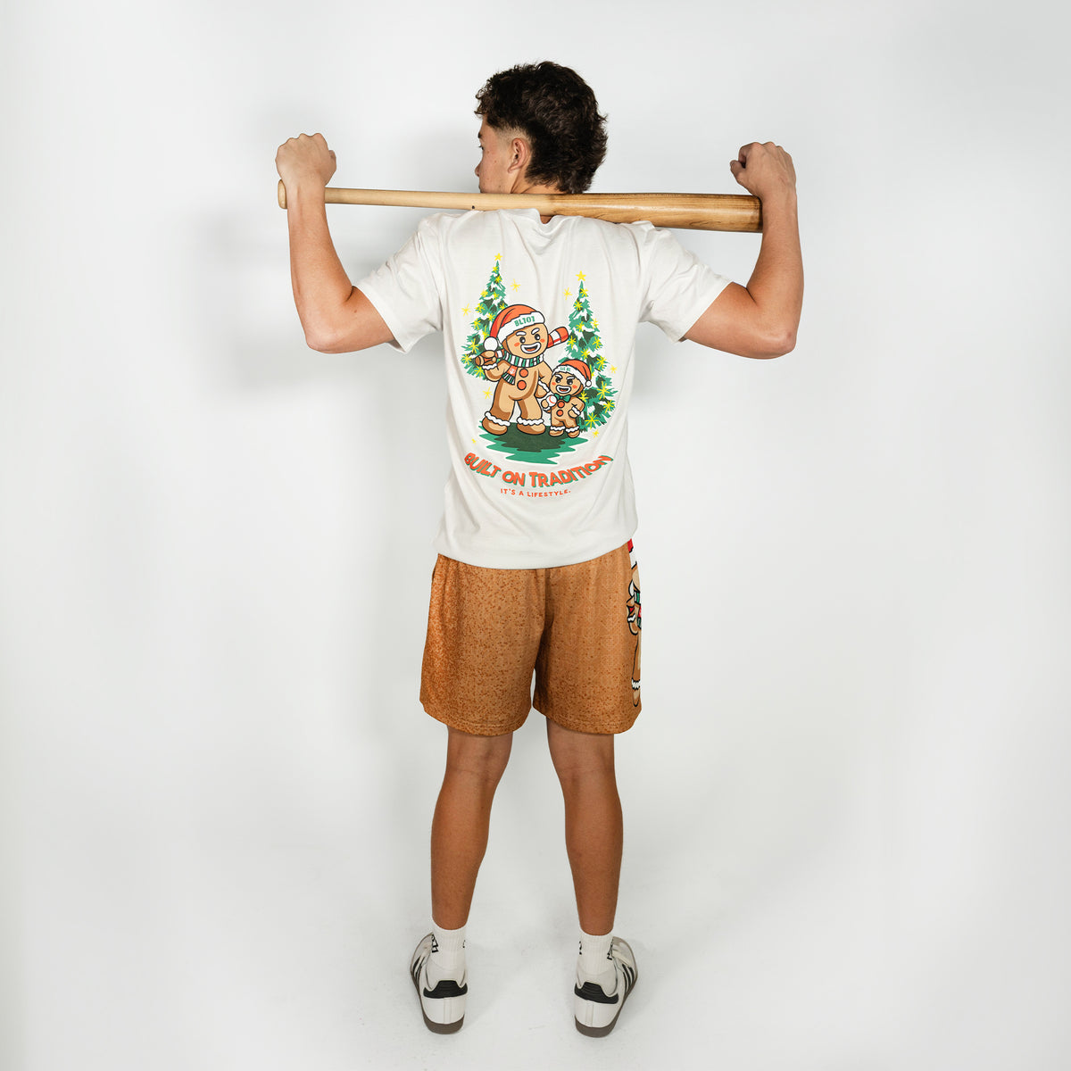 Adult model wearing brown shorts with "Gingerbread Rookie" design