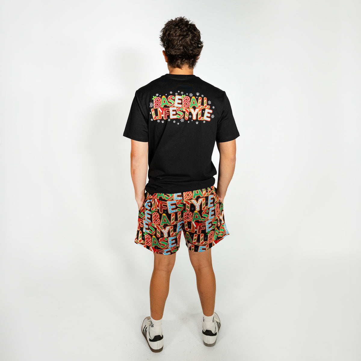 Adult model wearing multi-color shorts with "Holiday Cookie" design