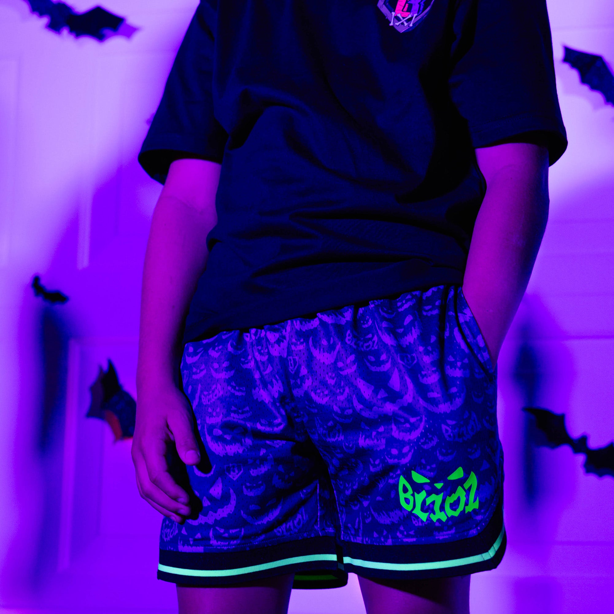 Adult model wearing purple shorts with "Jack O' Lantern Team" design