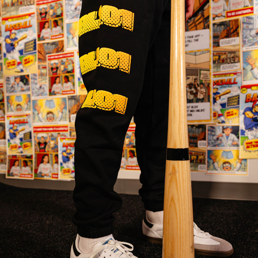 Adult model wearing black sweatpants with "Power Hitter" design