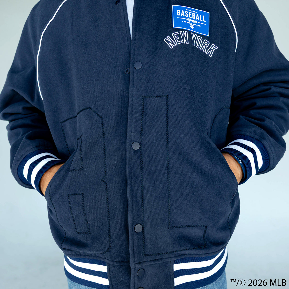 Adult model wearing navy New York Yankees Stadium bomber jacket