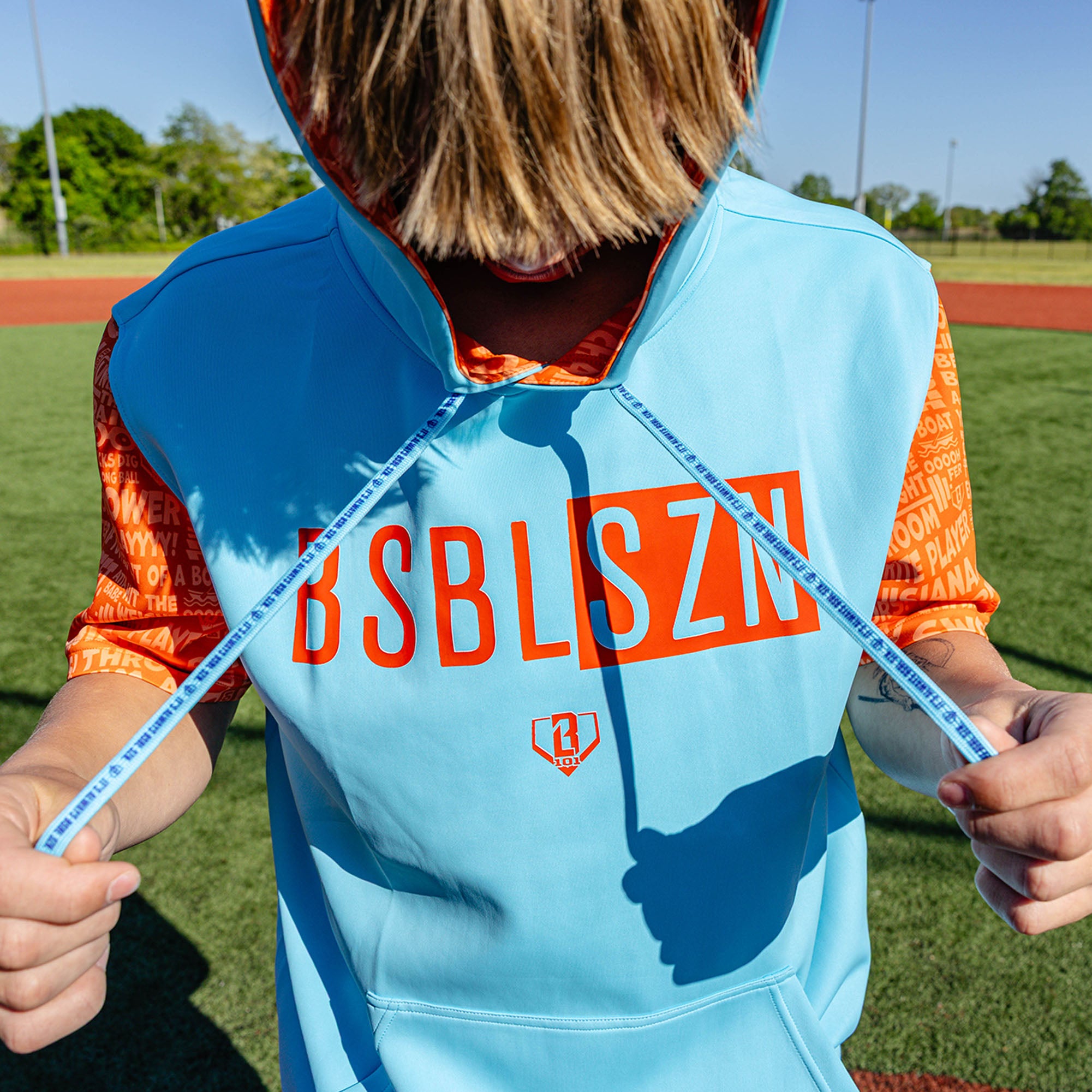 Adult model wearing blue short sleeve hoodie with "BSBL-SZN V3" design