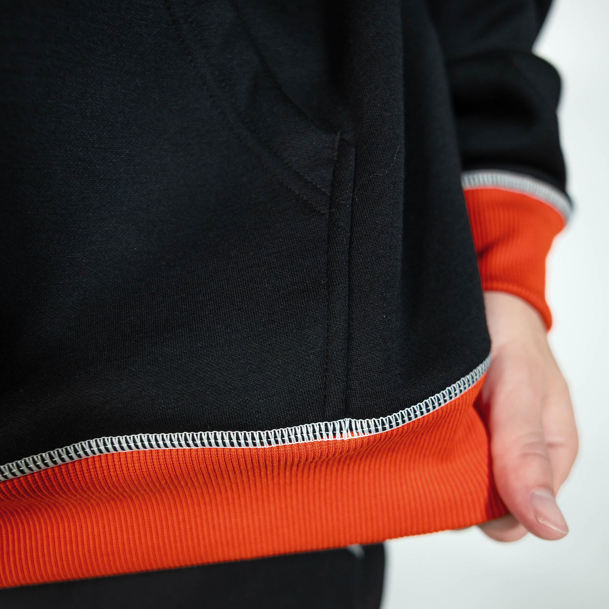 Adult model wearing black hoodie with "Holiday Cookie" design