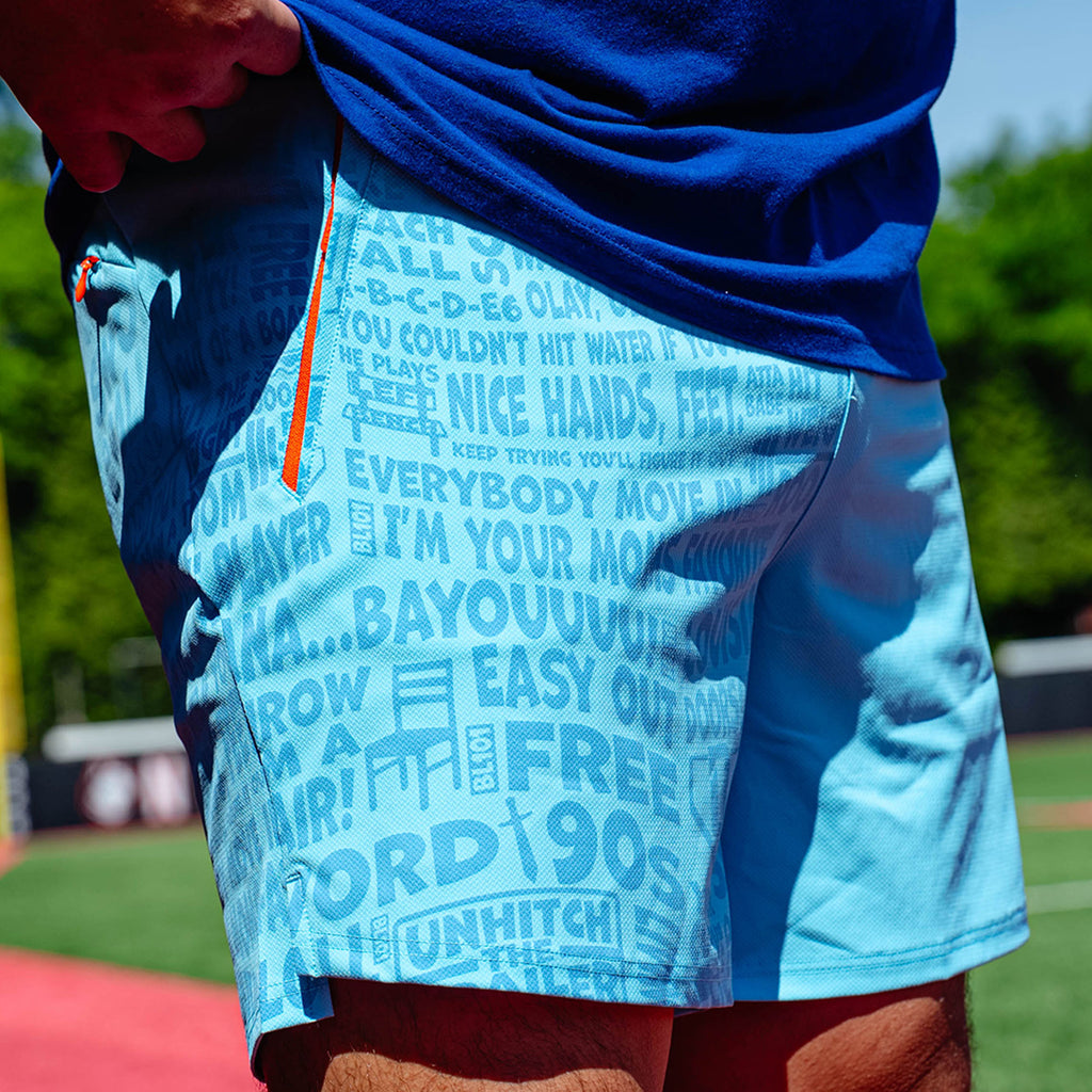Adult model wearing blue shorts with "UVChangeup Trash Talk" design