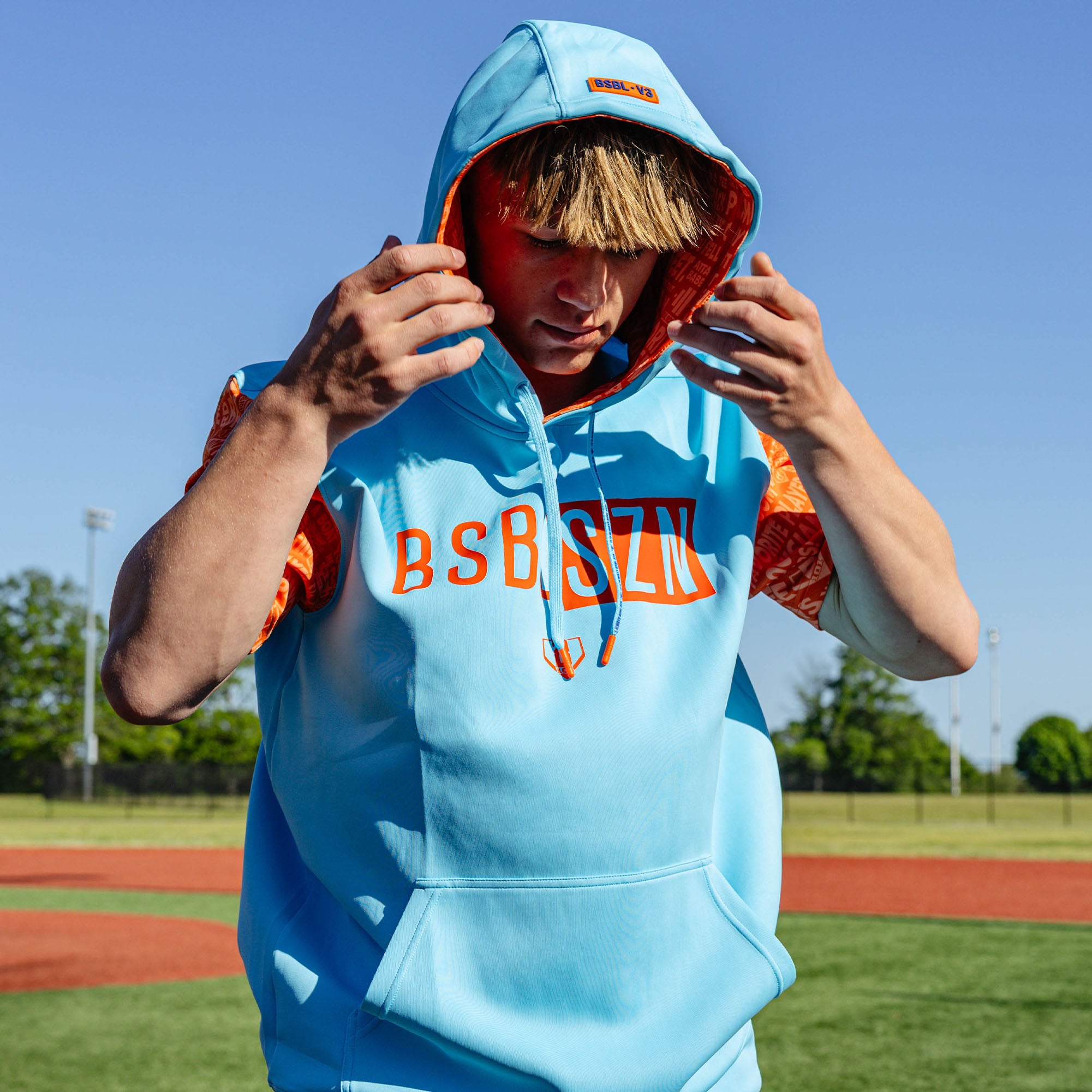 Adult model wearing blue short sleeve hoodie with "BSBL-SZN V3" design