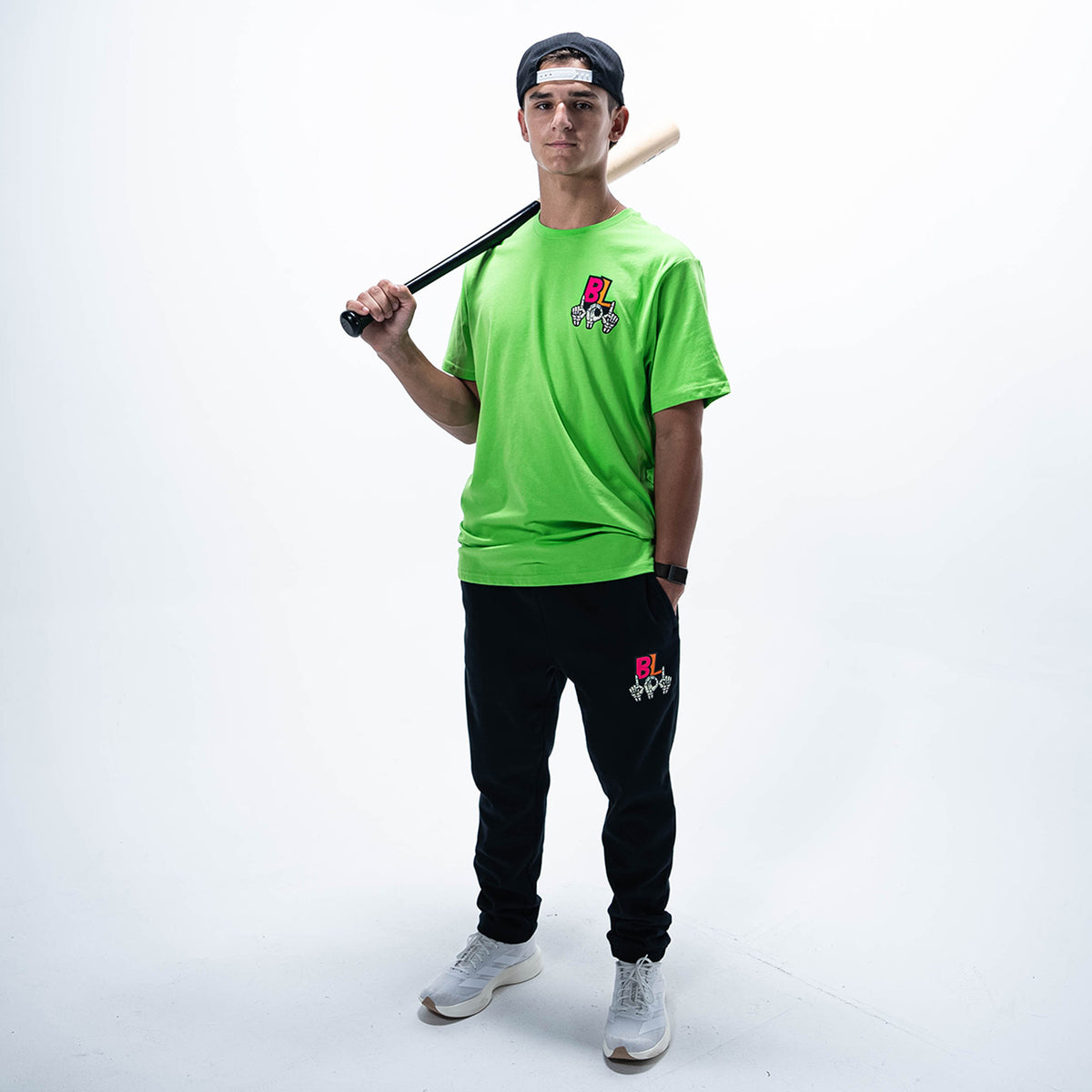 Adult model wearing green graphic tee with "101 Skeleton" design