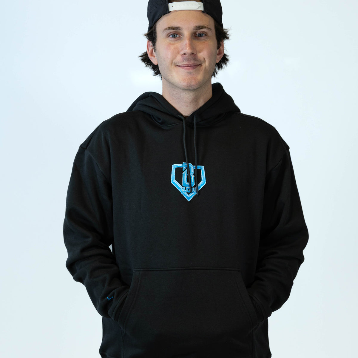Adult model wearing black hoodie with "10 Year Anniversary" design