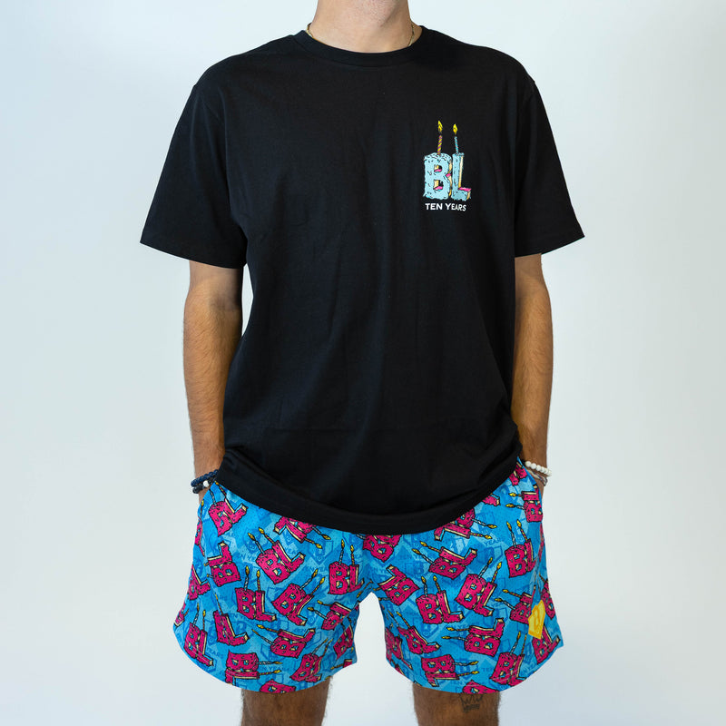 Adult model wearing blue shorts with "BL Birthday" design