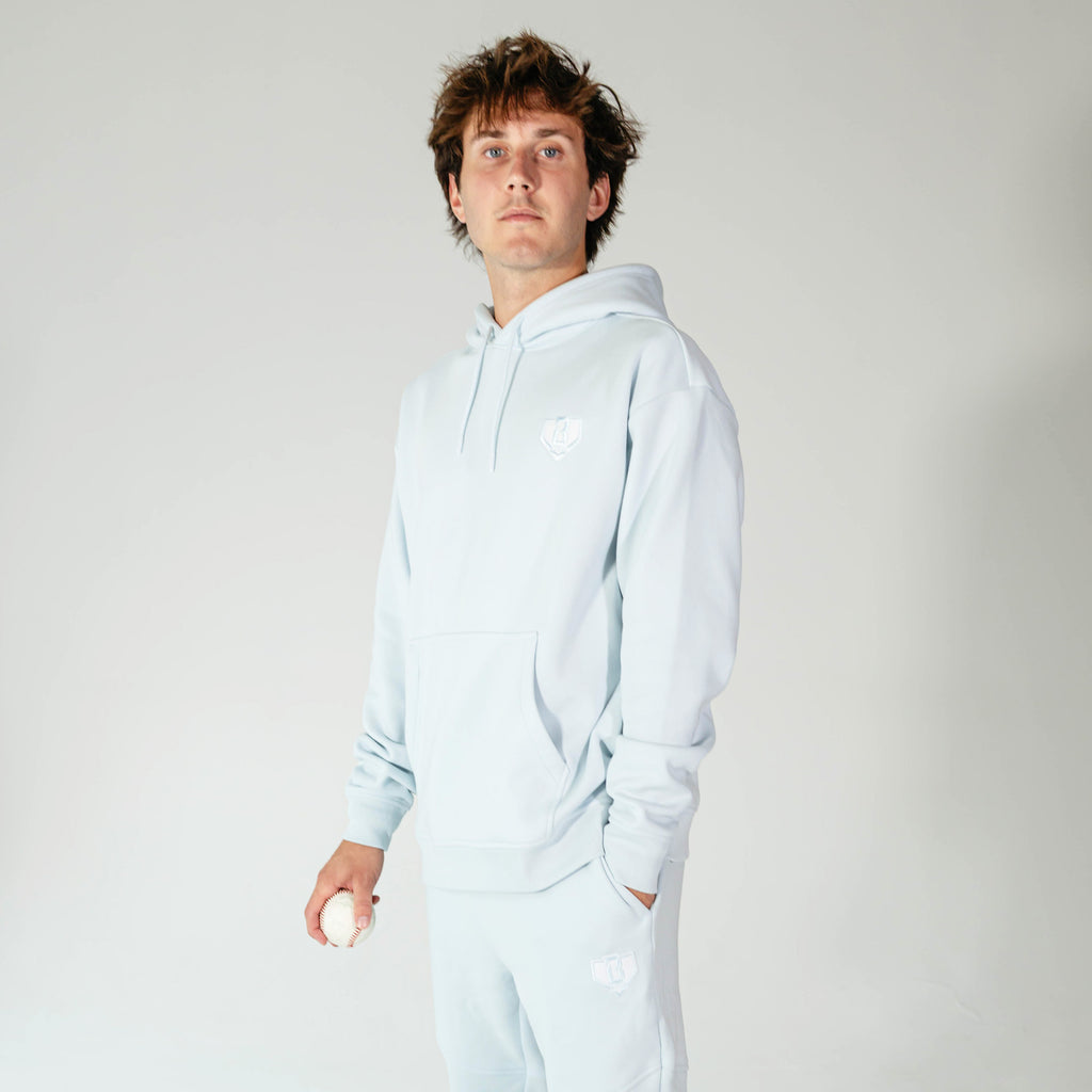 Adult model wearing Blue Baseline hoodie