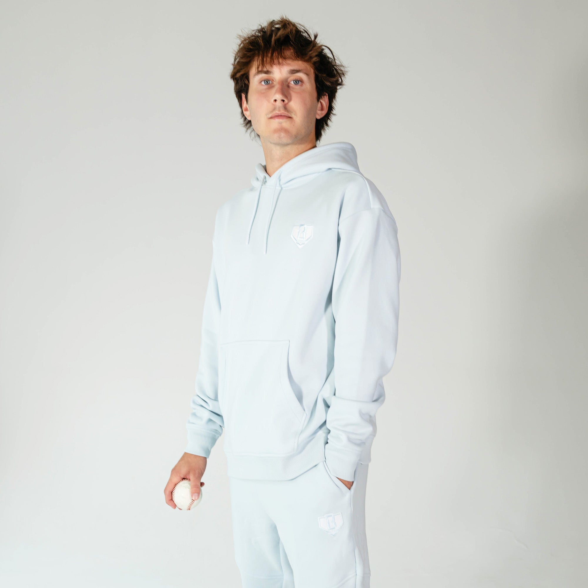Adult model wearing Blue Baseline hoodie